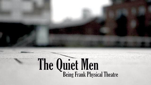 A blurred urban background with pavement in focus, featuring the text The Quiet Men and Being Frank Physical Theatre in bold black letters at the bottom of the image.