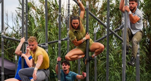 Motionhouse circus company - three acrobats suspended on vertical poles